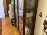 a glass case with books on top of it in a room