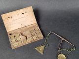 a small wooden box that has a pair of scissors in it