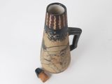 a brown and black vase with a wooden handle