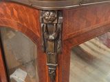 a wooden cabinet with a glass door and a metal handle