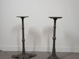 pair of antique cast iron candlesticks in the manner of person