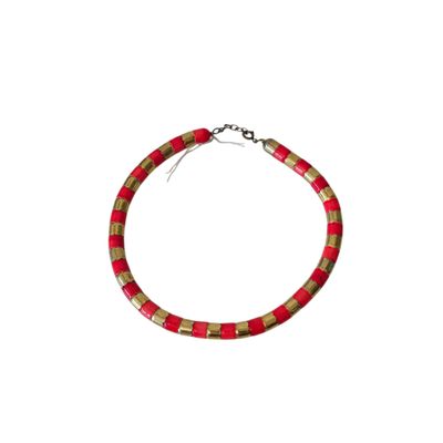 bracelet with red and gold beads and a silver clasp