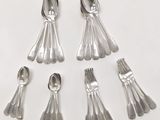 six silver spoons and six silver spoons on a white surface