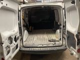 a white van with the door open in a garage