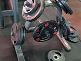 a gym room with a row of machines and weights