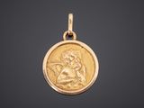 a gold coin with an image of a woman holding a baby
