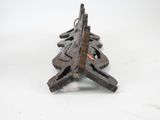 a small wooden christmas tree on a white surface