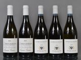 six bottles of wine are lined up in a row on a table