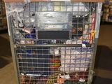 a metal cart with many items in it in a warehouse