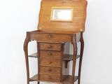 a small wooden desk with a mirror on top of it