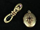 a gold locke with a pink stone in it and a gold locke with a pink stone in it