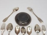 a lot of silver spoons and forks arranged in a circle