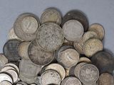 a pile of old silver coins on a table