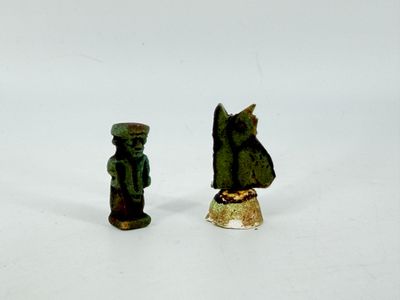 two figurines that are standing next to each other