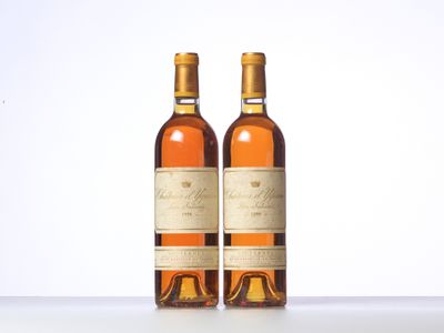 two bottles of wine sitting on top of a table next to each other