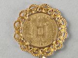 a close up of a gold coin on a white surface