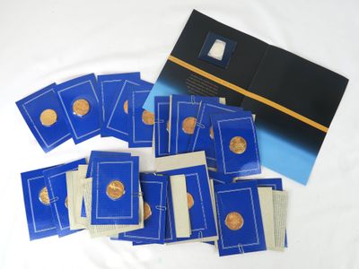 a pile of blue and gold coins on a white surface