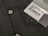 a label on the back of a jacket that has some diamonds on it