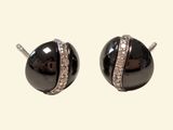 pair of black and white stud earrings with crystals on them