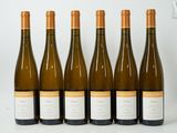 six bottles of white wine are lined up in a row