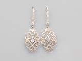 a pair of diamond and white gold earrings