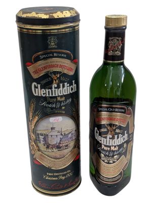 a bottle of whisky next to a canister