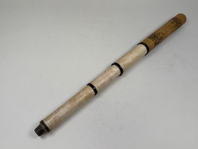 a close up of a pen on a table with a white background