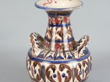 a blue and white vase with a bird on it
