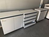 a white cabinet with drawers and a printer on top of it