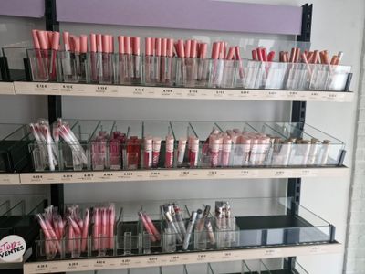 a lot of lipsticks on the shelves in the store
