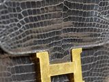 black crocodile skin handbag with gold hardware and handle