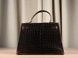 an image of a brown purse sitting on top of a wooden table