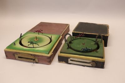two boxes with a clock on top of them on a white surface