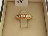 a gold ring in a box with a number 18 on it