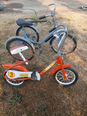 two bikes that are sitting in the grass