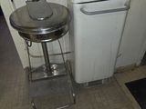 a trash can and a sink in a small room