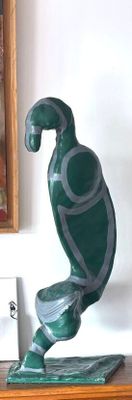 a statue of a turtle on a shelf next to a painting