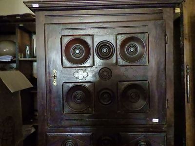 a wooden cabinet with many knobs on top of it