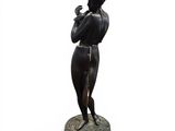 bronze statue of a woman holding a bird on a pedestal