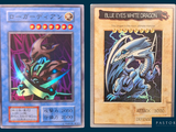 two pokemon cards with blue eyes and white dragon on them