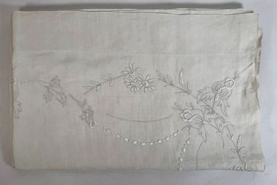 a white cloth with a design of flowers on it
