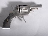 a gun that is sitting on a white surface