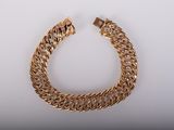 une image d'un bracelet en or sur fond blanc