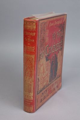 an old book sitting on top of a white table next to a white wall