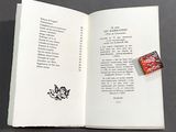 an open book with a stamp on it on a table
