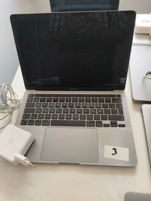 a laptop computer sitting on top of a desk with a charger