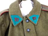 a green jacket with red and blue patches on it