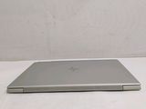 a laptop that is sitting on a white surface