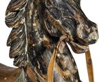 a wooden horse with a saddle on it ' s back