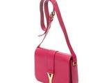 a pink bag with a gold y logo on the front